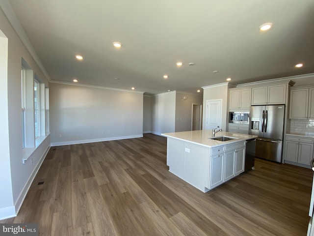 kitchen featuring built in microwave, dishwasher, stainless steel fridge with ice dispenser, a center island with sink, and hardwood / wood-style flooring