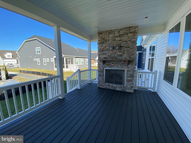 deck with an outdoor stone fireplace