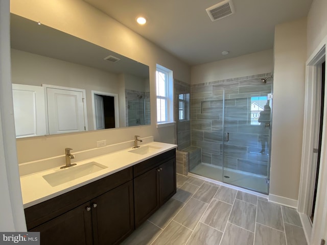 bathroom featuring vanity and a shower with shower door