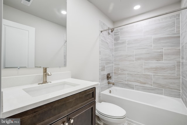 full bathroom featuring vanity, toilet, and tiled shower / bath