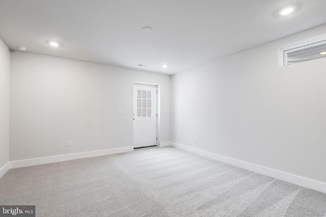 unfurnished room with light carpet