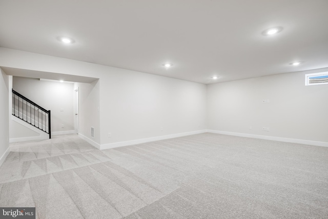 basement featuring light colored carpet