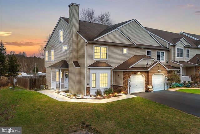 view of front of property with a yard and a garage