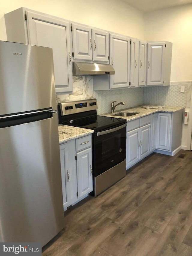 kitchen with backsplash, dark wood-type flooring, white cabinets, and stainless steel appliances