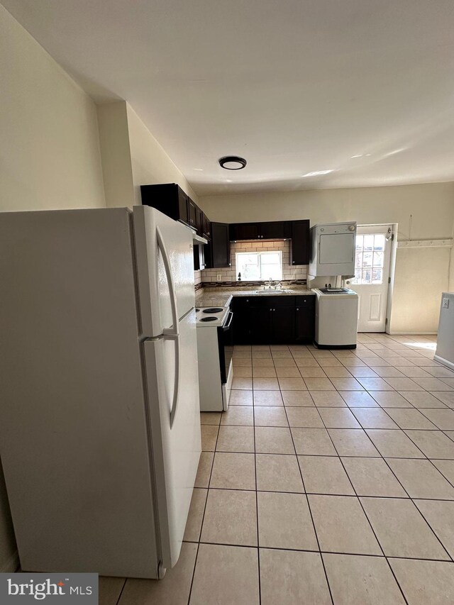 1600 S Taney St, Philadelphia, PA 19145 - kitchen featuring freestanding refrigerator, range with electric cooktop, light tile patterned flooring, decorative backsplash, and dark cabinetry