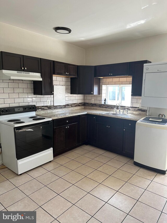 1600 S Taney St, Philadelphia, PA 19145 - kitchen with range with electric cooktop, under cabinet range hood, a sink, backsplash, and stacked washer and clothes dryer