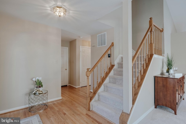 staircase with hardwood / wood-style flooring