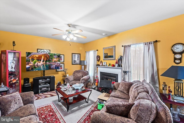 carpeted living room featuring ceiling fan