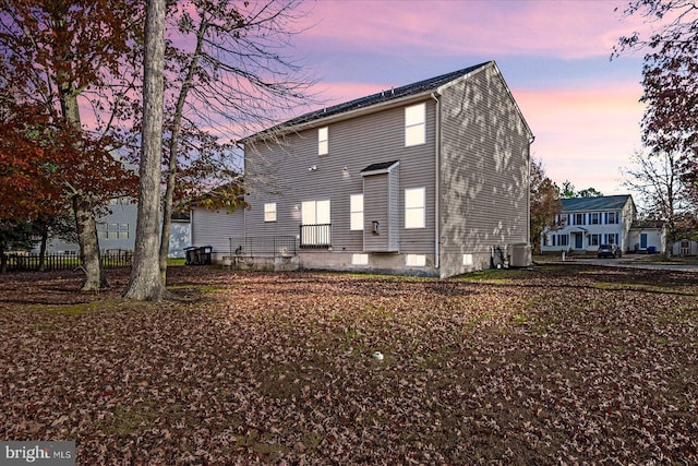 back house at dusk with central AC unit