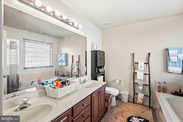 bathroom with a tub to relax in, tile patterned floors, and vanity