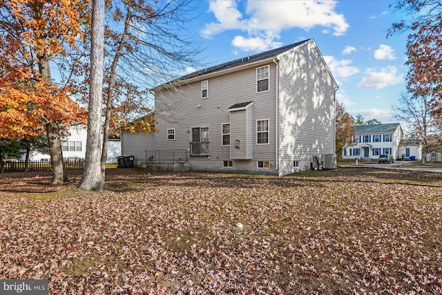 rear view of house with central AC unit