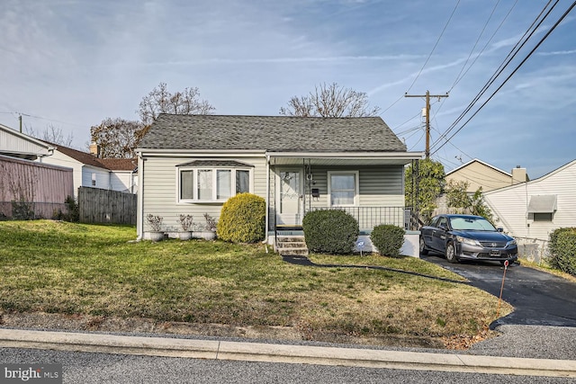 bungalow-style home with a front yard