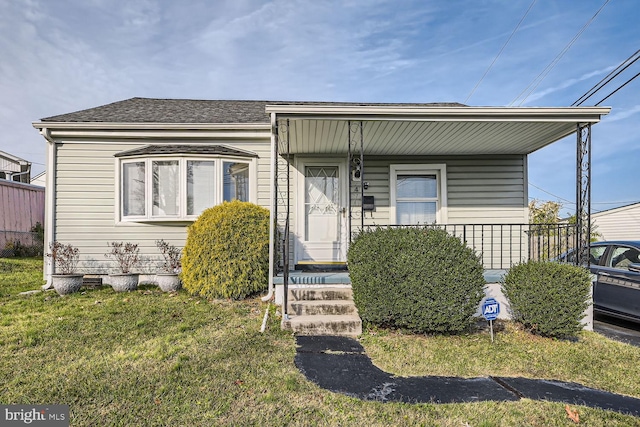 view of front of house with a porch and a front lawn