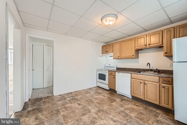 kitchen with white appliances, a drop ceiling, and sink