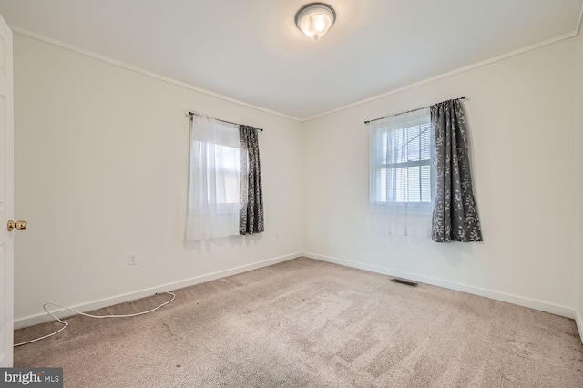 carpeted empty room featuring ornamental molding