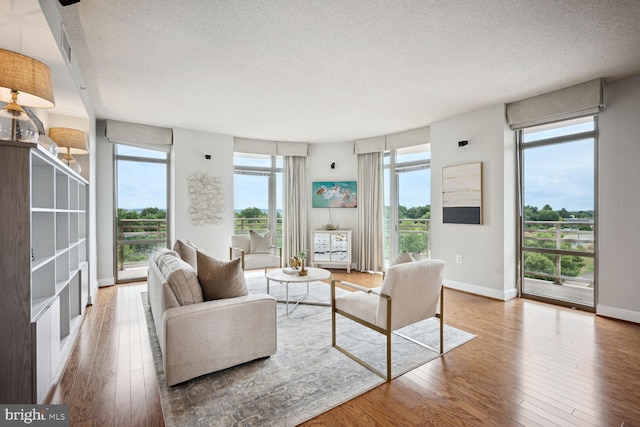 living room with plenty of natural light, a textured ceiling, and hardwood / wood-style flooring