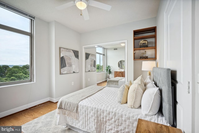 bedroom featuring hardwood / wood-style flooring and ceiling fan