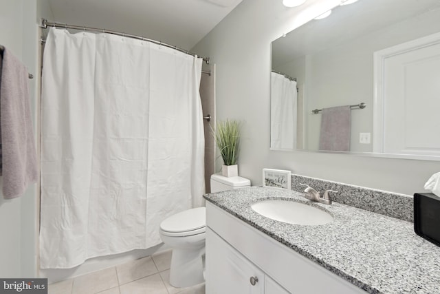 bathroom with tile patterned flooring, a shower with curtain, vanity, and toilet