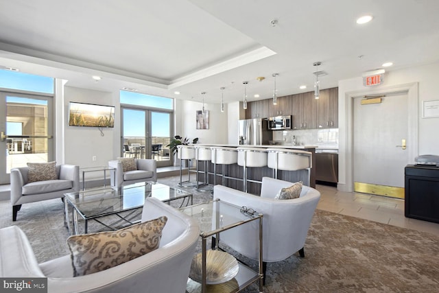 living room featuring a raised ceiling