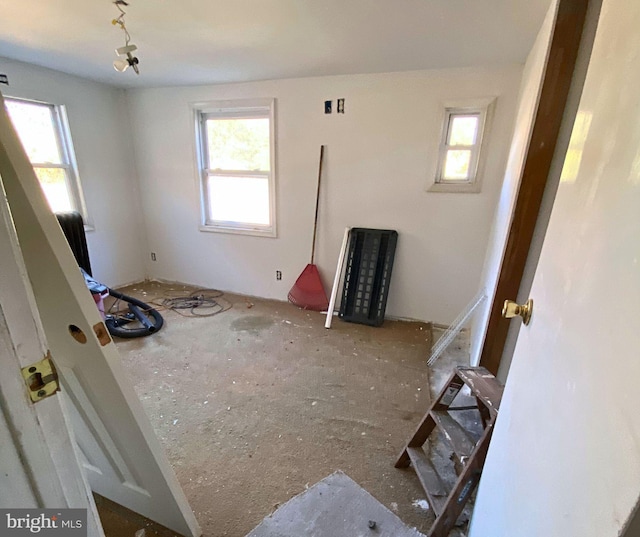 unfurnished bedroom featuring multiple windows