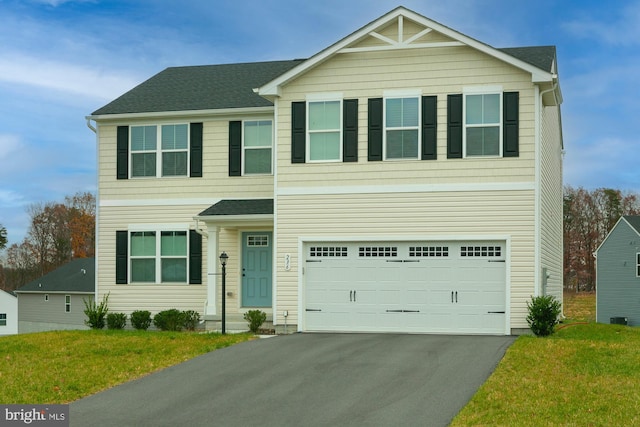 view of front facade with a garage and a front yard