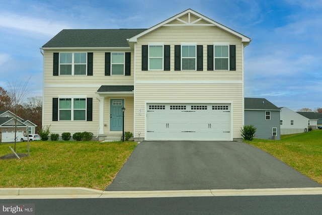 view of front of house featuring a garage and a front yard