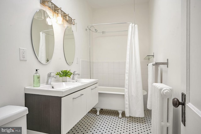 full bathroom with toilet, vanity, shower / tub combo with curtain, and radiator