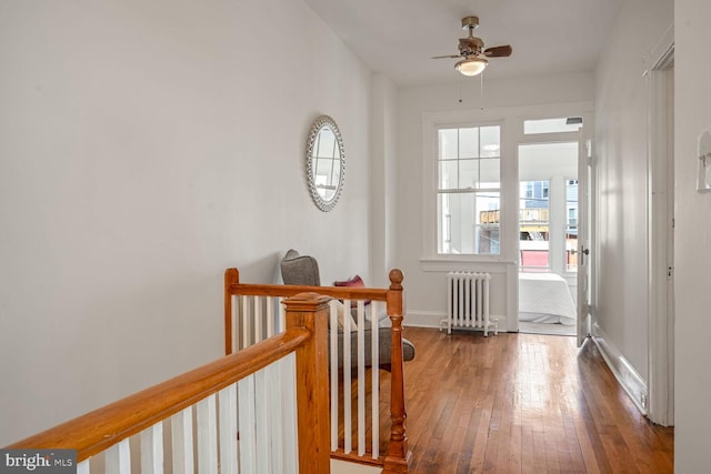 hall featuring radiator heating unit and wood-type flooring