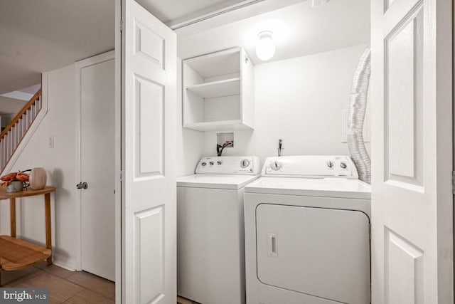 laundry room with hardwood / wood-style flooring and independent washer and dryer