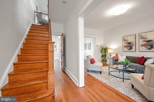 staircase with hardwood / wood-style flooring