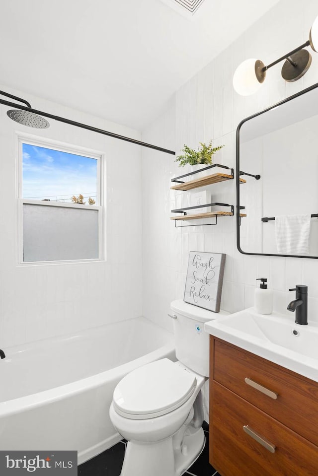 full bathroom with vanity, tiled shower / bath, decorative backsplash, toilet, and tile walls