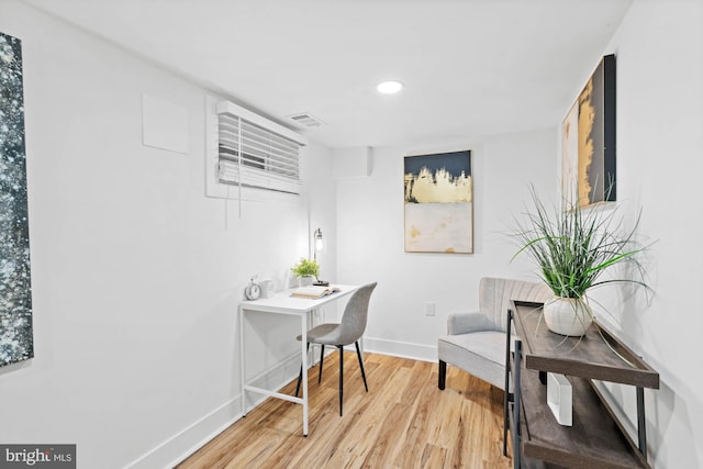 home office with hardwood / wood-style floors