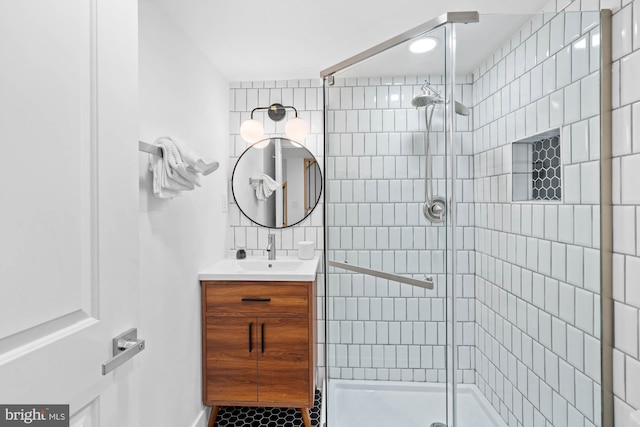 bathroom with vanity and a shower with shower door