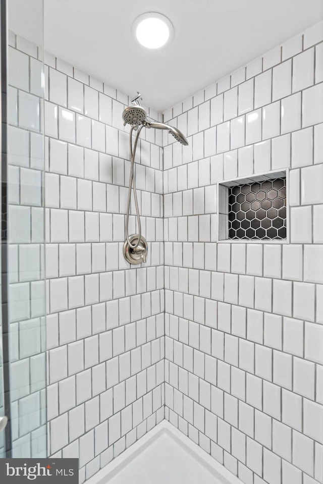 bathroom with tiled shower