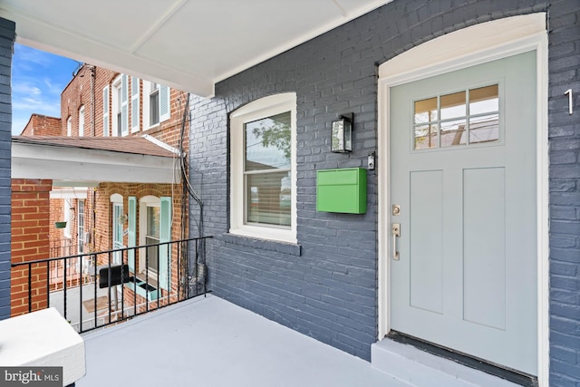 view of exterior entry with a porch