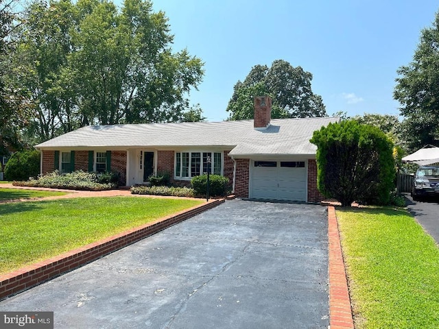 ranch-style home with a front lawn and a garage