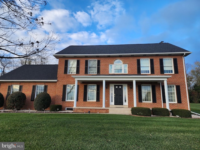 colonial home with a front yard