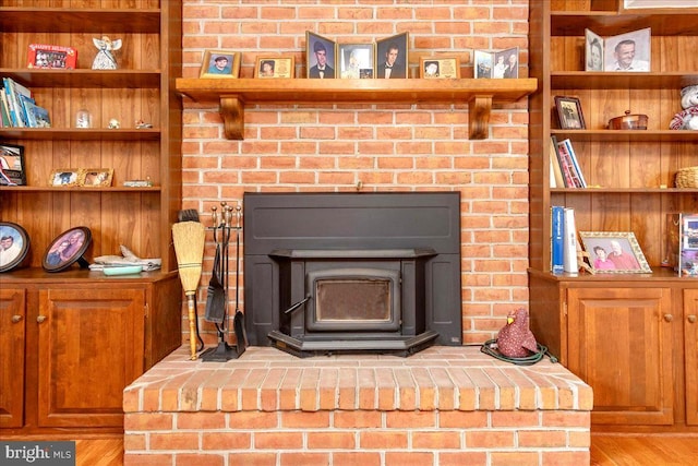 room details featuring a wood stove and wood-type flooring