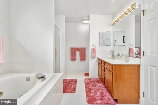 bathroom with tile patterned floors, separate shower and tub, and vanity