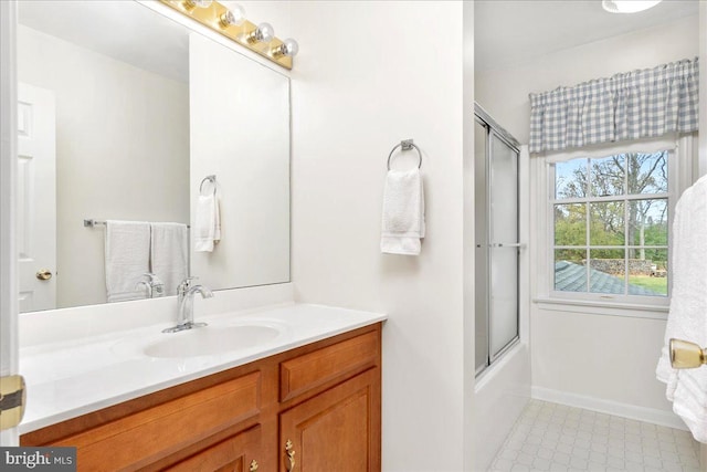 bathroom featuring vanity and bath / shower combo with glass door