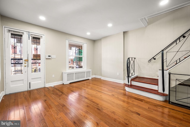 entrance foyer featuring radiator heating unit, french doors, and hardwood / wood-style flooring