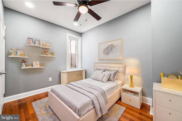 bedroom with radiator heating unit, light hardwood / wood-style flooring, and ceiling fan