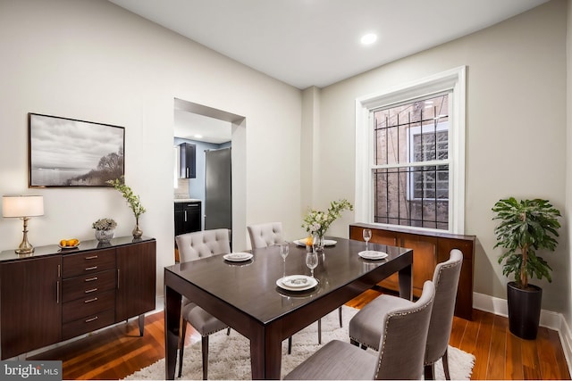 dining space with dark hardwood / wood-style floors