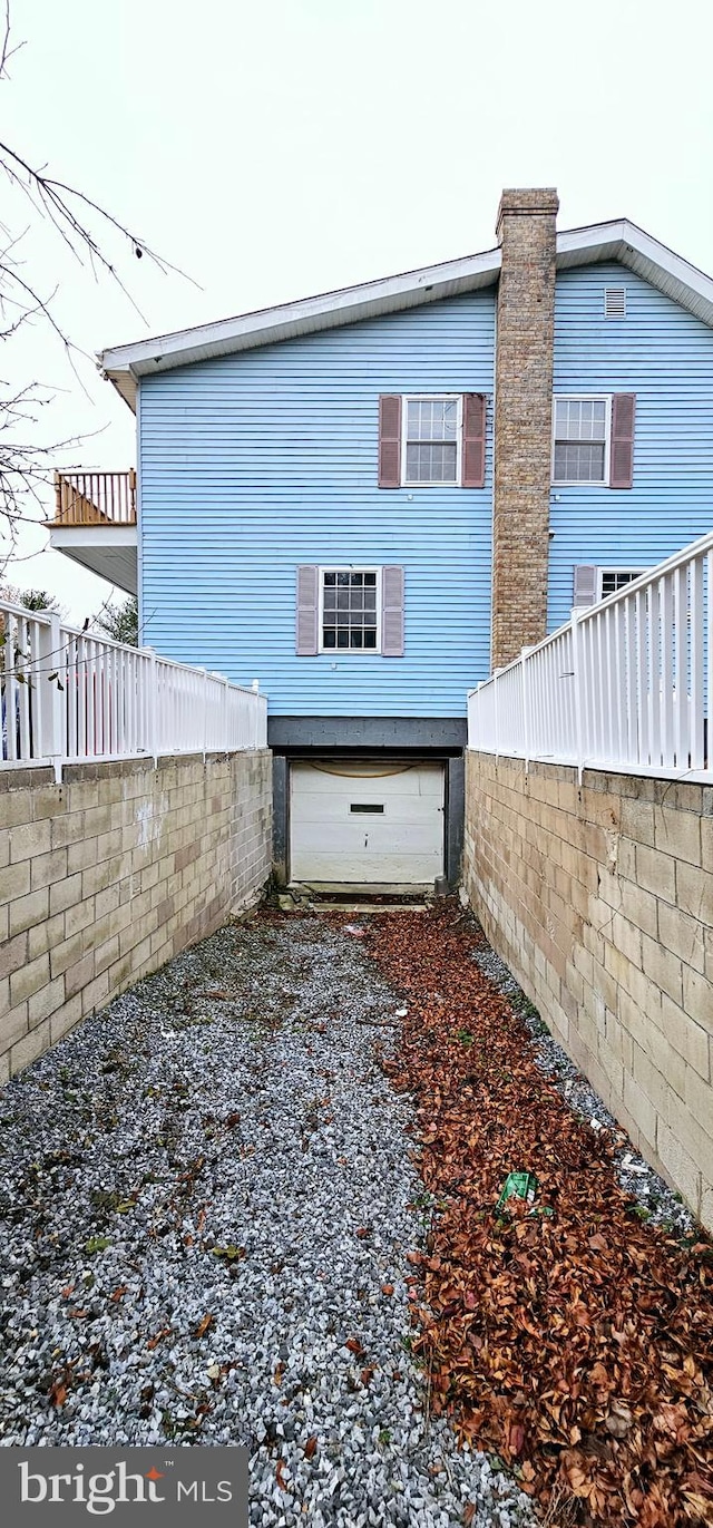 back of house with a garage