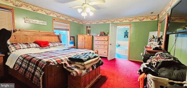 bedroom featuring carpet, ensuite bathroom, and ceiling fan