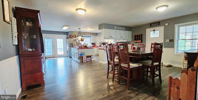 dining area with french doors and dark wood-type flooring