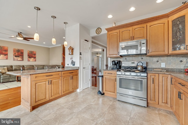 kitchen with ceiling fan, ornamental molding, appliances with stainless steel finishes, decorative light fixtures, and kitchen peninsula