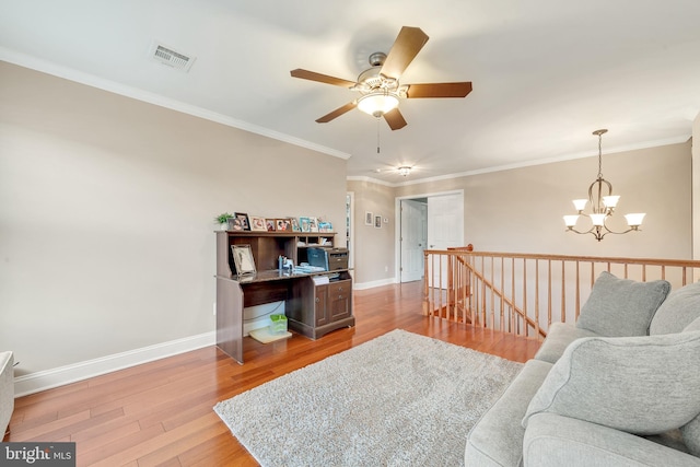 home office featuring hardwood / wood-style floors, ceiling fan with notable chandelier, and ornamental molding