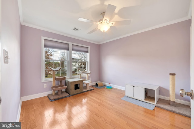 miscellaneous room with ceiling fan, ornamental molding, and light hardwood / wood-style flooring