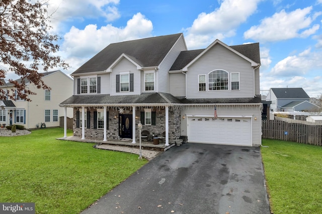 view of front facade featuring a front yard, a porch, and a garage